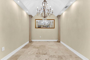 Custom layout w/ expanded dining room, upgraded dining light fixture & roman columns