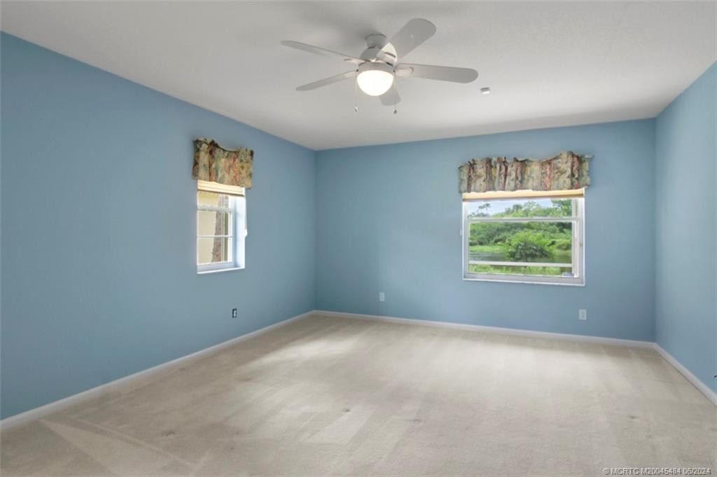 master bedroom with window overlooking the pond
