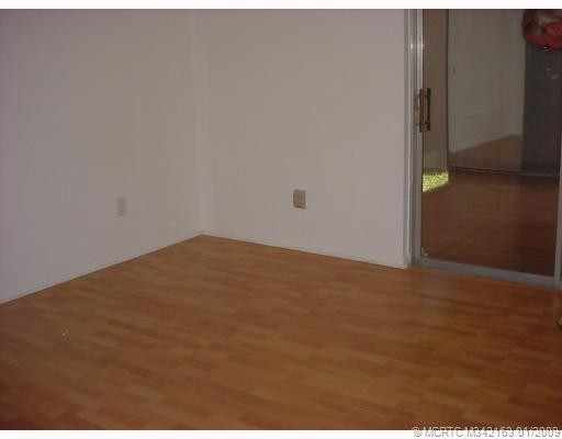 Master Bedroom. Master bedroom has wood floors and sliders to glassed-in porch.