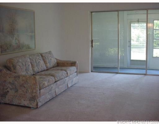 Living Room. Living room has newly installed plush beige wall to wall carpeting. Also has pocket sliders to porch.