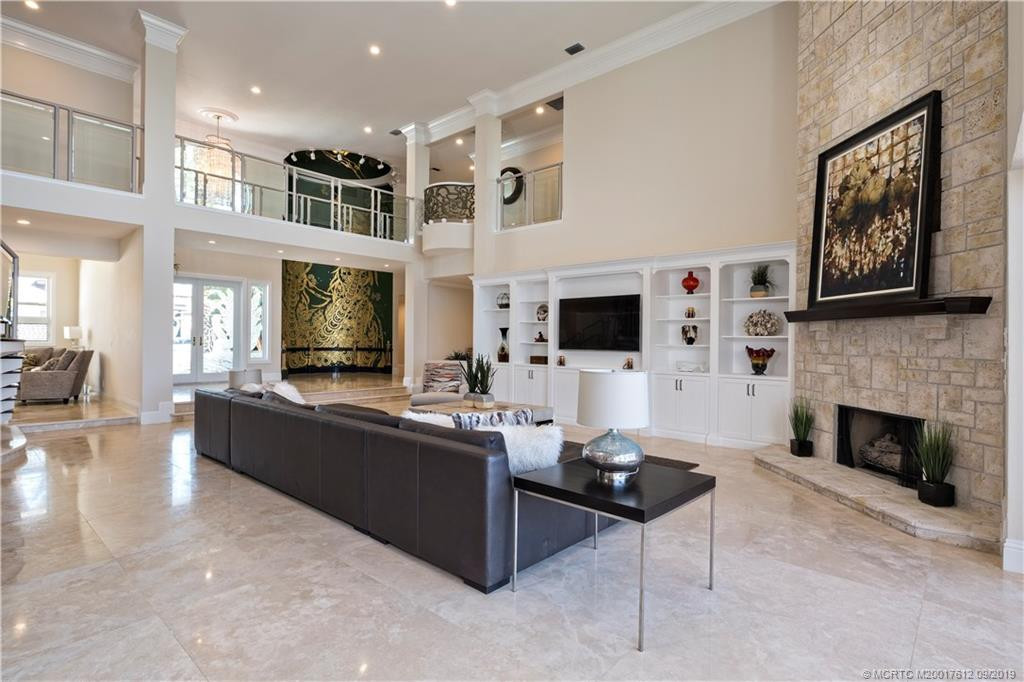 Open and bright greatroom with volume ceilings and gas fireplace.