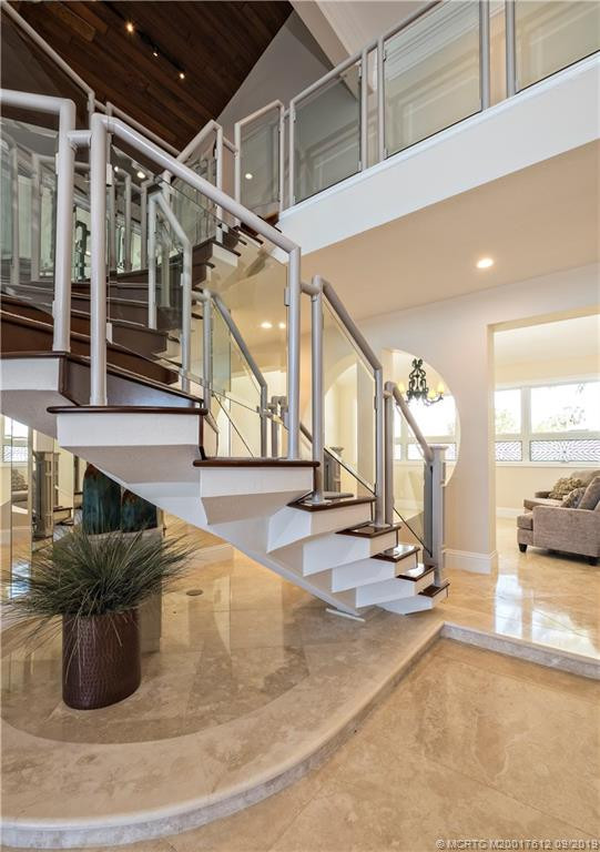 Staircase to second level loft/game room/media room/office with bamboo floors.