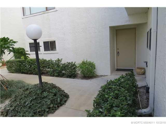 Exterior Front. Private entrance amid lush landscaping and quaint outdoor light