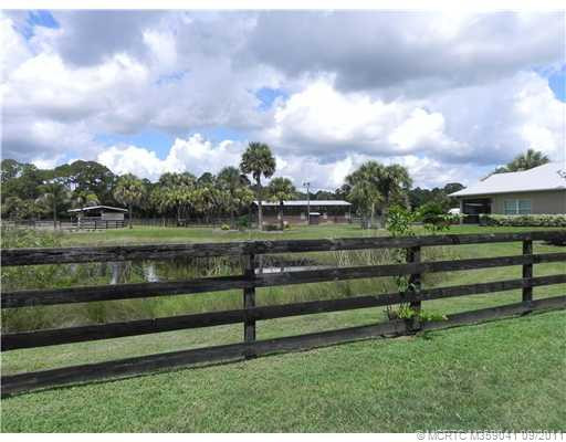Exterior Front. Shows two field stalls and pond