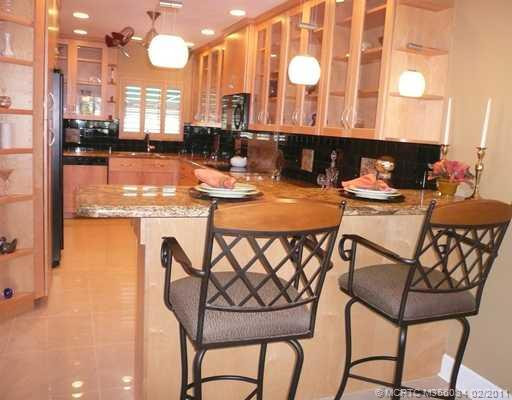 Kitchen. Expanded & extended custom Granite Kitchen features raised ceiling, solid maple cabinetry, breakfast bar, architectural lighting & ceiling fan, new porcelain tile floor. Bar chairs negotiable.