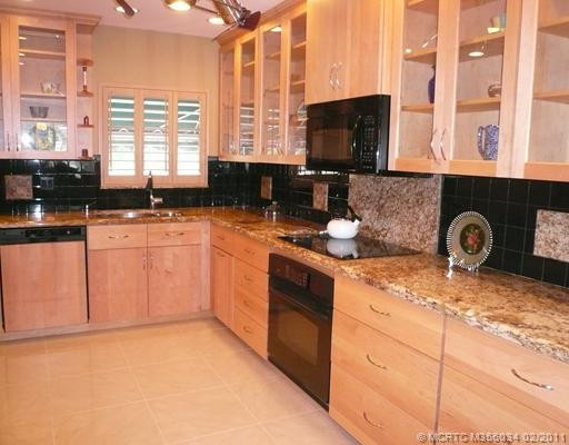 Kitchen. Pull-out drawers & custom 42" cabinets w/crown molding create ample storage in completely renovated granite kitchen. GE top-of-the-line appliances are a chef s delight.