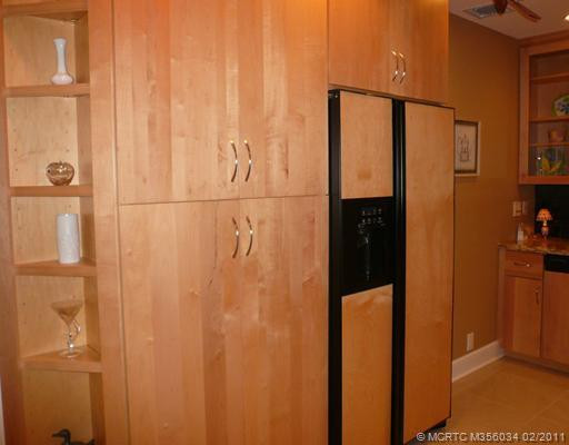 Kitchen. GE Profile Refrigerator with custom panels matches solid wood maple cabinetry & is recessed into pantry wall