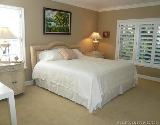 Master Bedroom. Tranquil Corner Master Bedroom has freshly painted insulated walls & smooth, spray painted ceiling, new ceiling fan, crown molding, new carpeting, wide baseboard, Plantation Shutters & a nice water view on two sides. Bedroom furnishings negotiable.