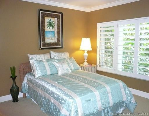 Other. Crown molding, spray painted smooth ceiling, freshly painted walls, new carpeting, wide baseboard, Plantation Shutters, PGT impact glass casement windows in Guest Bedroom create a relaxing ambience
