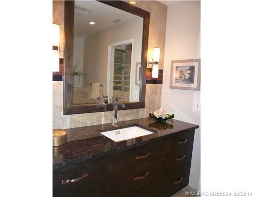 Other. Guest Bath features Italian marble & granite, framed mirror, designer porcelain basin & chrome faucet, custom ebony vanity w/drawers, architectural lighting. Frameless glass marble shower with Italian Aqua Brass fixtures also in this bathroom.
