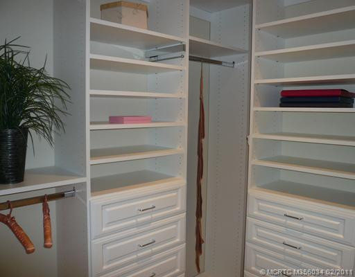 Other. Master Walk-in Closet customized by Artistic Closets, features ample hanging & shelf space, 2 jewelry drawers, tie racks & valet bars (photo shows 1/2 of closet). Attic access from this closet.