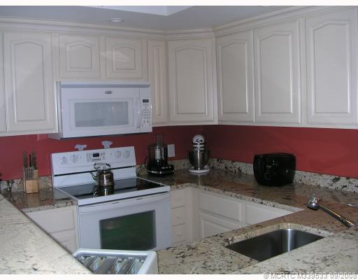 Kitchen. THIS QUAD/SANDALWOOD MODEL BOASTS A FABULOUS KITCHEN RENOVATION WITH WONDERFUL CABINETS, GORGEOUS GRANITE, NEW , TOP OF THE LINE APPLIANCES, NEW SINK AND PORCELAIN TILE FLOORS!!