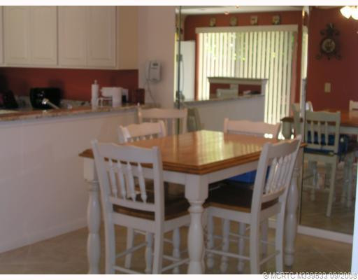 Dining Room. PORCELAIN TILE, MIRRORED WALL AND OPEN TO KITCHEN MAKE THIS A BRIGHT DINING AREA!