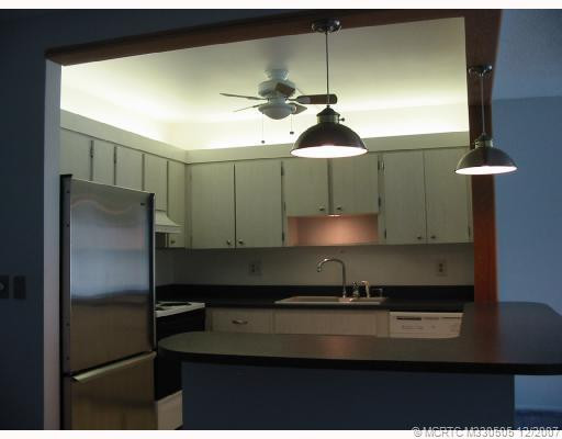 Kitchen. Newer stainless refrigerator with open breakfast bar area