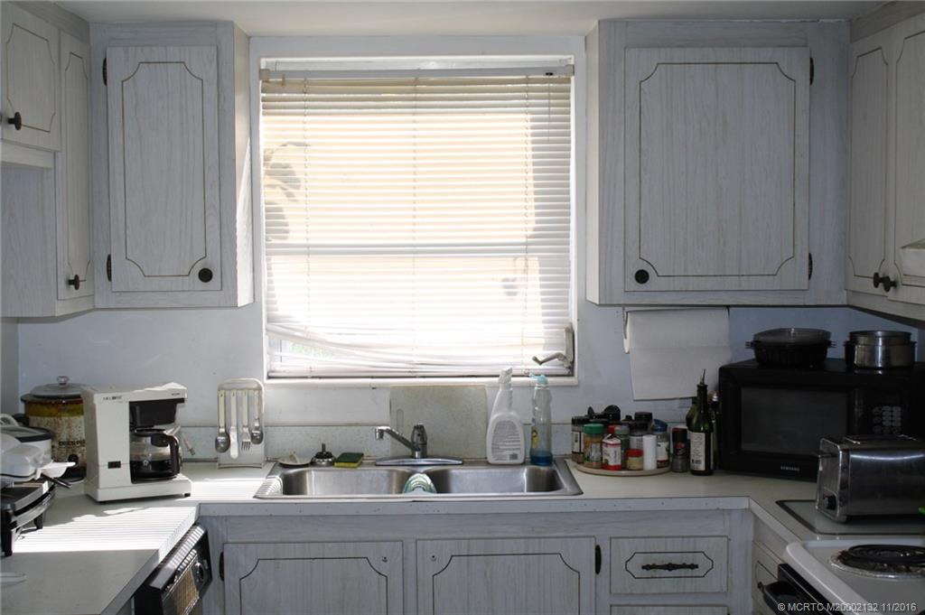 The kitchen is bright with a large window over the sink. There is a convenient pass through to the dining room.