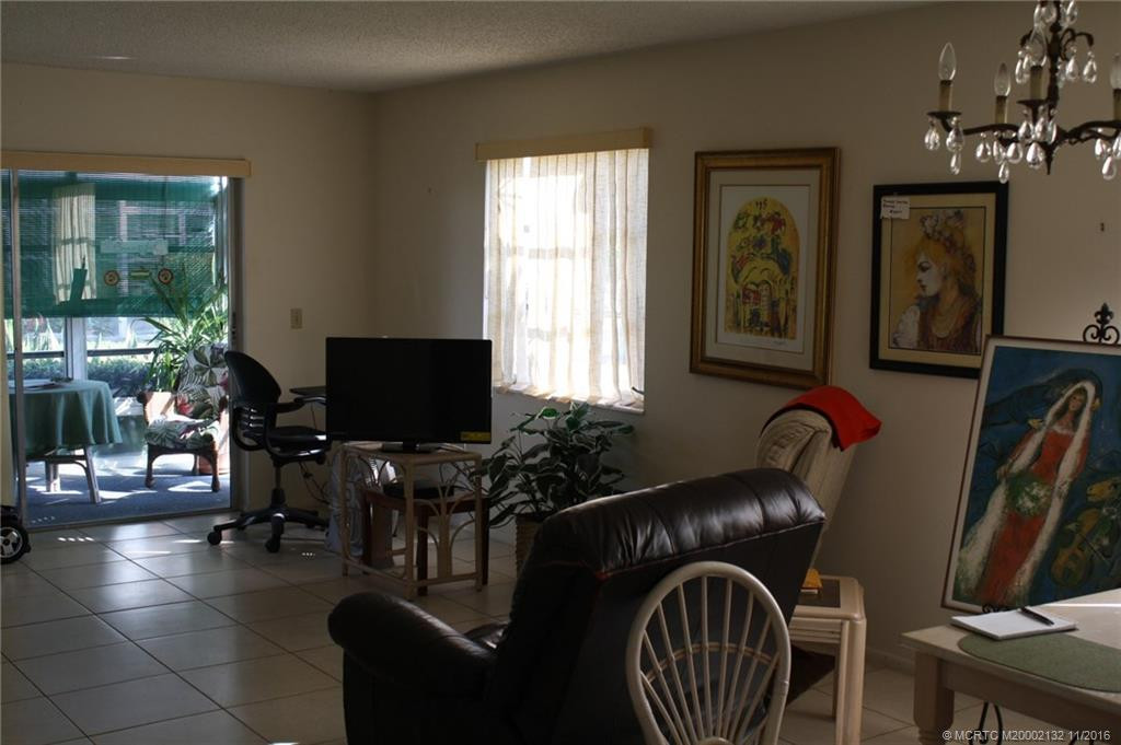 The large tile is attractive and easy care. The living room opens to the enclosed porch.