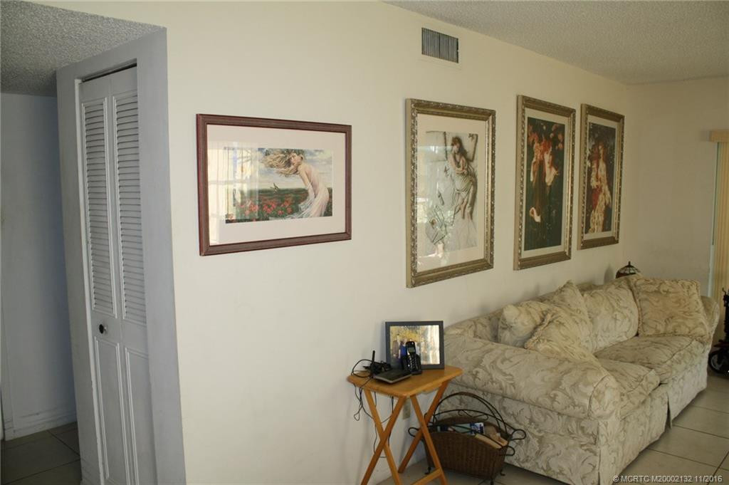 The spacious living room is tiled and opens to the enclosed porch.