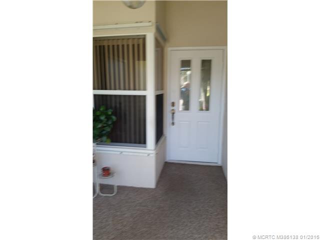 Exterior Front. Front porch area with entrance to garage