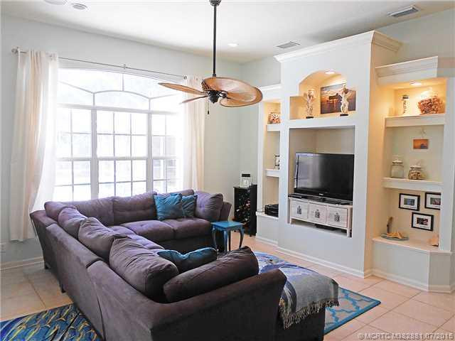 Living Room. Built-in shelves for pictures and entertainment set. Fresh paint, crown molding, and baseboards.