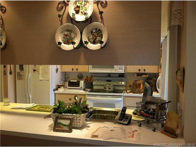 Kitchen. Kitchen has open bar area from living room/dining room