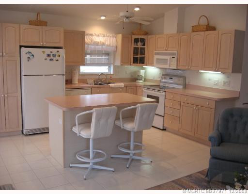 Kitchen. Side view of very large kitchen with breakfast bar & 2 stools