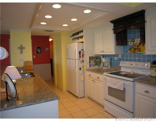 Kitchen. New lighting, counter tops of granite, appliances, and backsplash too! Come see this panoramic penthouse unit!