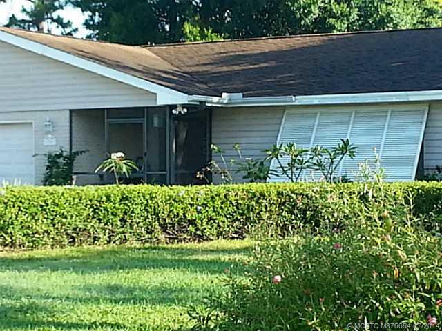 Exterior Front. Screened entry and Bahama style shutters