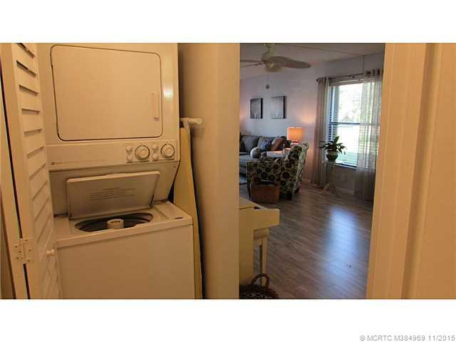 Other. Washer and dryer inside the condo situated in hallway area with Plantation style new closet doors