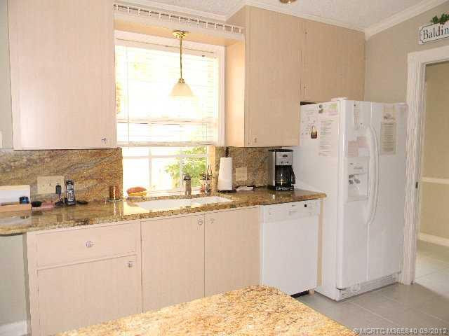 Kitchen. Beautiful granite counters and backsplash w/ matching knobs update the kitchen.