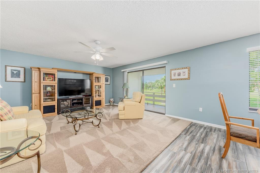 Living room has new carpet and a nice view of the golf course