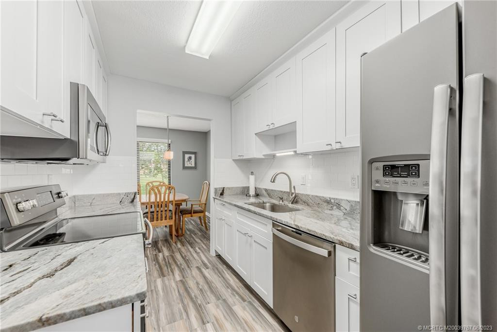 The kitchen opens up directly into the dining room. Easy smart access for step saving days