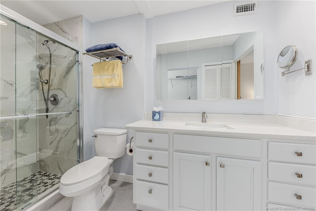 Master bath has the new coastal vibe cabinetry and marble shower