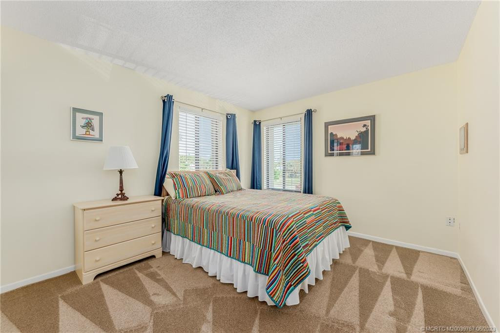 Guest bedroom is large and neutral shades make it ready to match any décor you may have.
