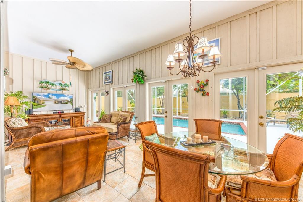 The Florida Room Addition is the perfect space to watch a ball game or play a game of cards!! Gorgeous French doors lets nature in! Owner is leaving the wide screen TV!!!