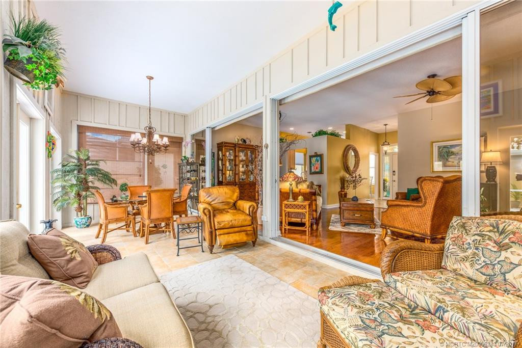 You will never want to leave the cozy Florida Room with walls of glass, Tile Floors, upgraded lighting, custom paint & panoramic views of the pool & gardens!