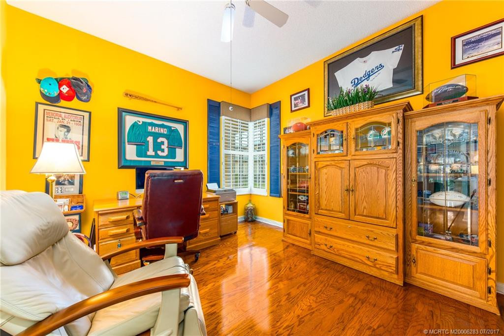 Guest Bedroom/Den/Office/Music Room with beautiful hardwoods, spacious closet, ceiling fan & custom blinds.
