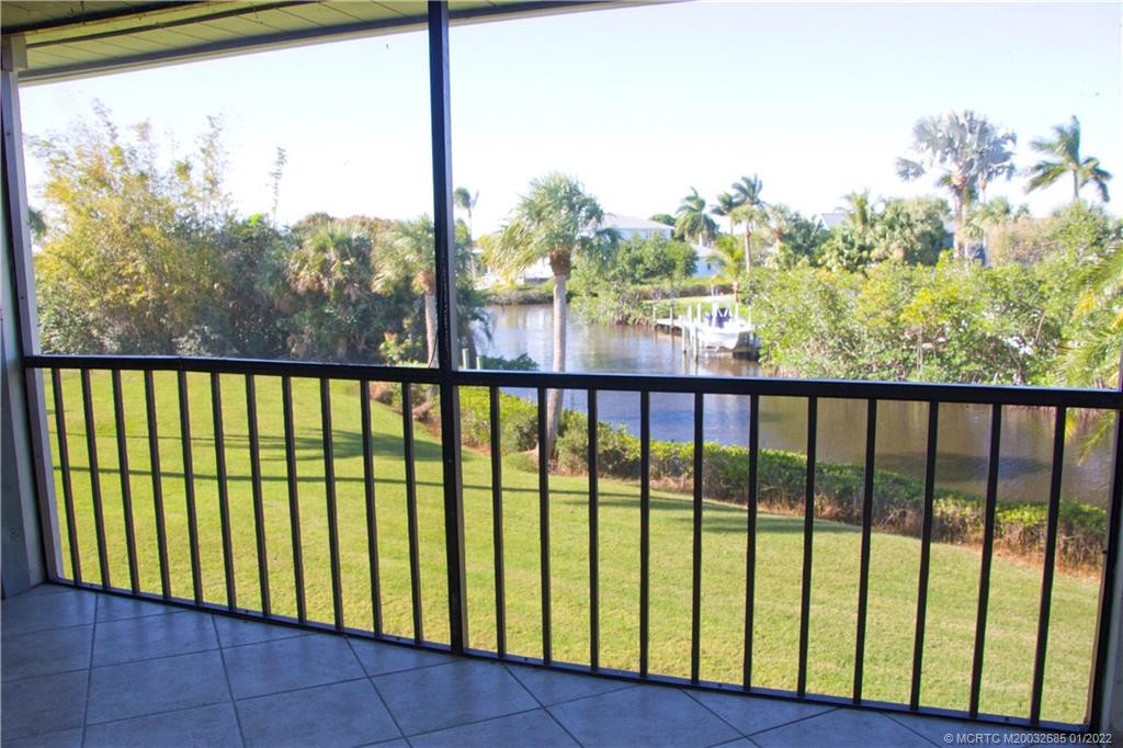 Screened covered balcony with canal view