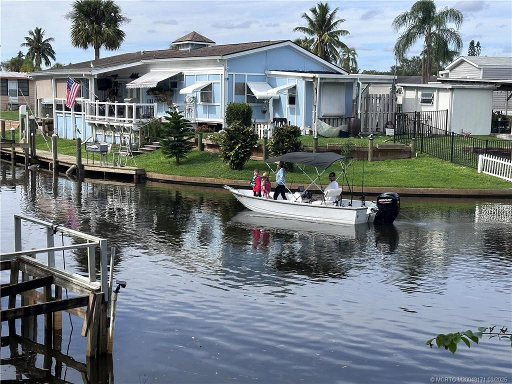 Boater on water in canal behind 7802 SE Paradise