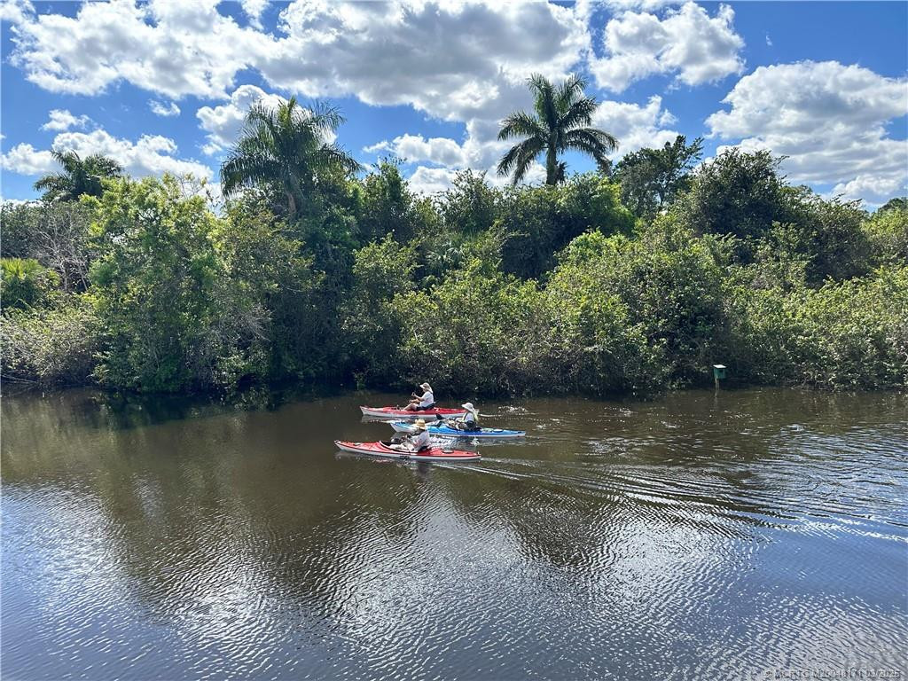 Kayakers on waterway nearby
