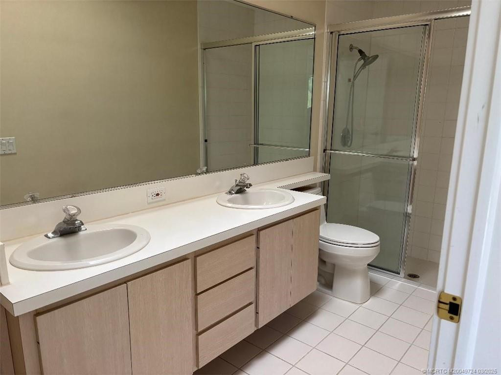 Master bath with double sink and walk-in shower