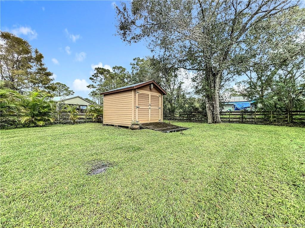 Shed WITH A RAMP FOR THAT EXTRA STOARGE LOOK AT THE YARD AND MORE ALL AROUND YOU, CITY WATER AND SEPTIC ON THE PROPERTY.