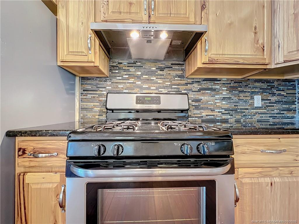 Gas Stove, beautiful back splash. Lot of cabinets.