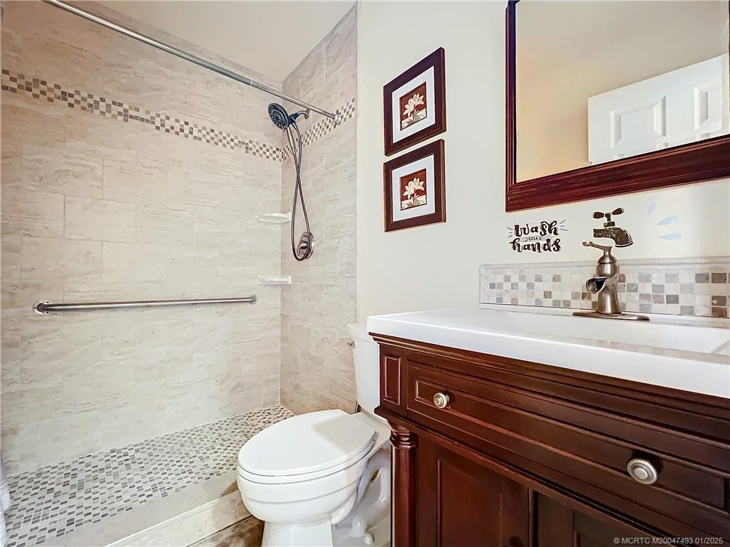 Guest bathroom with a large shower, all updated, beautiful tile and updated vanity. Safety bars.