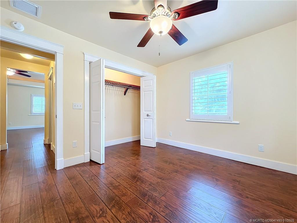 This is the closet in the guest bedroom. Go down the hall with a guest bathroom with large tiled shower combined. Fan with a light