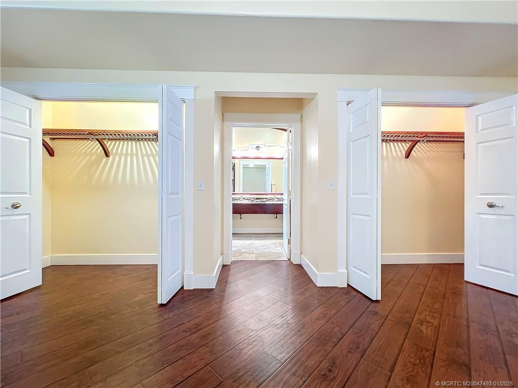 2 Large closets, laminate wood floors,, fresh paint, the door in front is to the primary bathroom. Doble sinks, large shower with a window