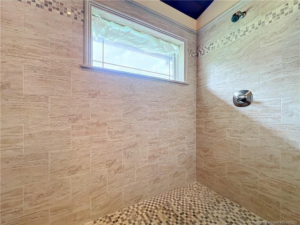 this is the other shower head on the other side of the large shower. acroos the whole leftside of the bathroom with an impacat window.