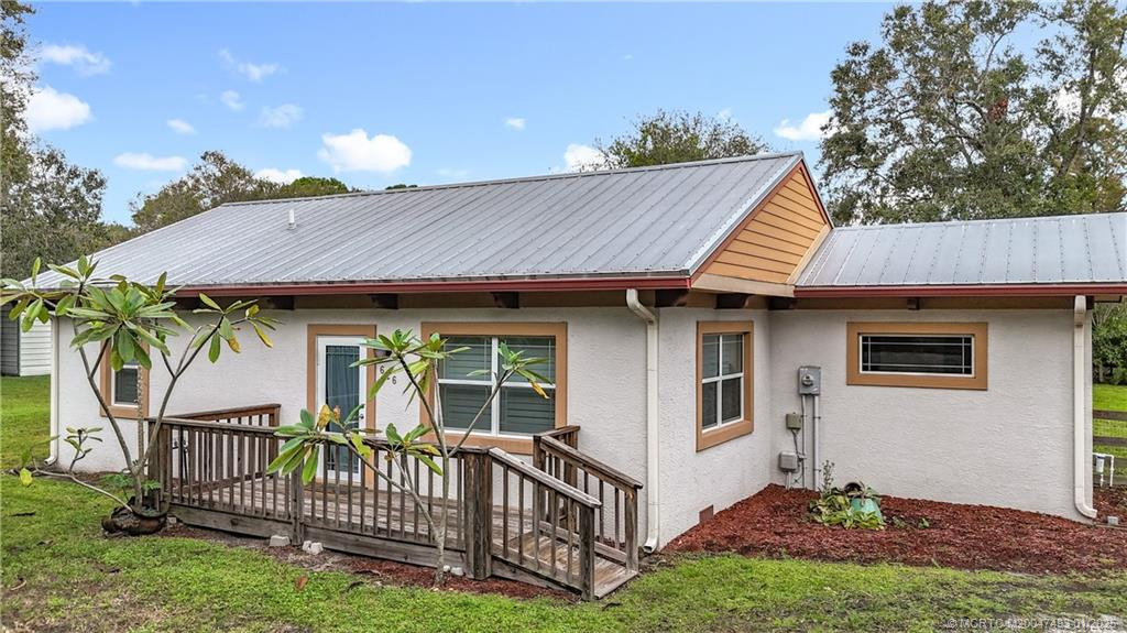 Nice front porch with a ramp. CBS home with stucco.