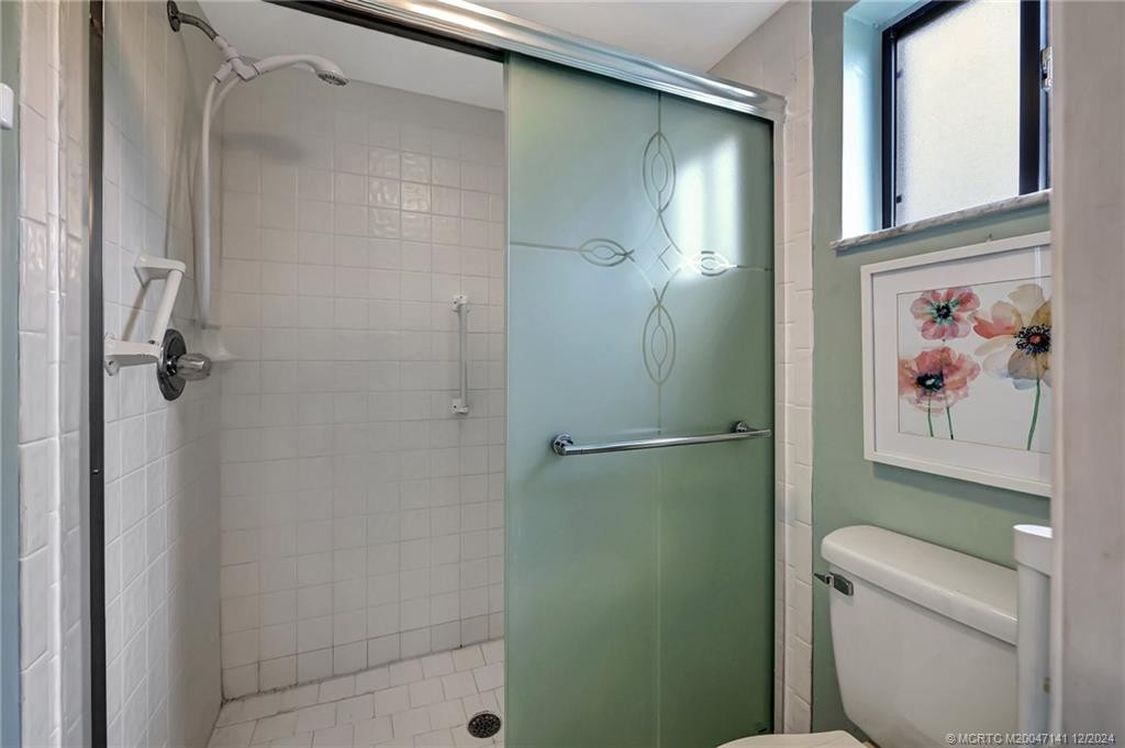 Step in shower in the primary en suite bathroom.