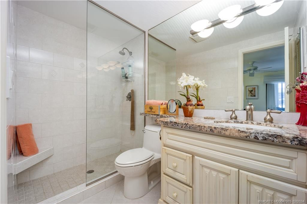 Updated with granite vanity, tiled frameless shower and new lighting fixture.
