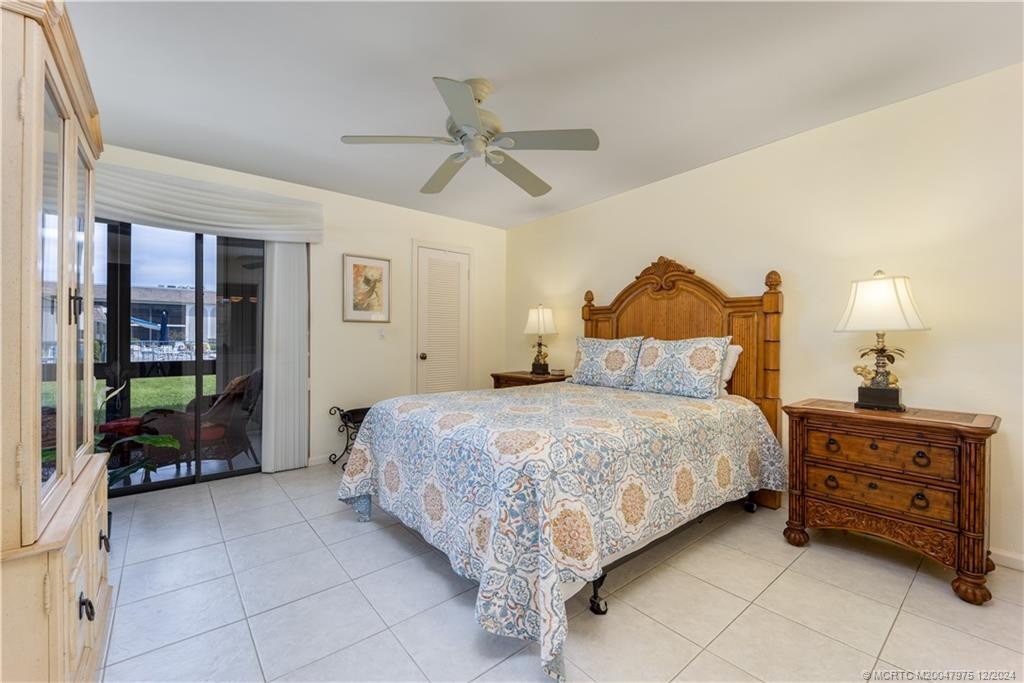 Bright primary bedroom with walk-in closet and slider to lanai.